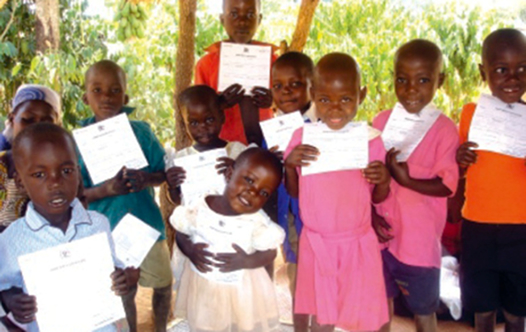 Ugandan children proudly show off their birth certificates